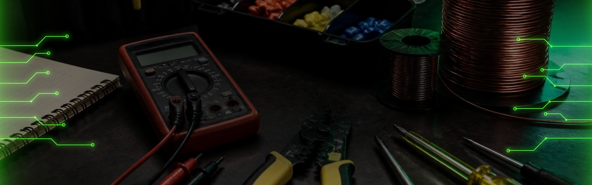 Electrician's multimeter, wire strippers and wire spools on a workbench